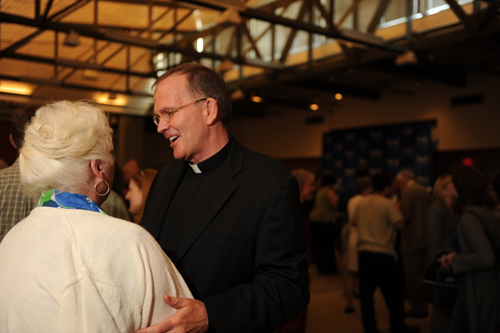 Father O'Connell speaking with RIta Bogley 