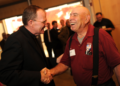 Father O'Connell shaking hands with Jack Denka 